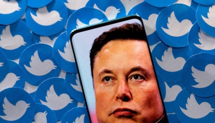 An image of Elon Musk is seen on a smartphone placed on printed Twitter logos in this picture illustration taken April 28, 2022. — Reuters/File