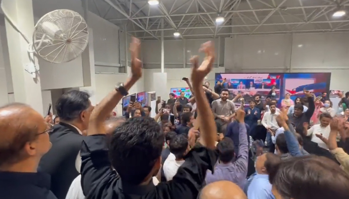 PTI workers celerbating at the partys main election office during the Punjab by-election, on July 17, 2022. — Twitter/PTI