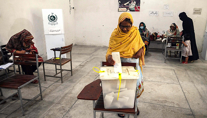 Voters cast their ballot at a polling station during the by-election in the Punjab province assembly seat in Lahore on July 17, 2022. — AFP