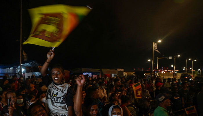 Demonstrators take part in a celebration as Sri Lankas protest movement reached its 100th day at the Galle face protest area near Presidential secretariat in Colombo on July 17, 2022. — AFP