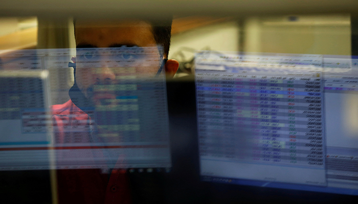A computer screen is reflected in the glass window of a booth where a broker is monitoring the market in the halls of the Pakistan Stock Exchange, a day after an attack in Karachi, Pakistan June 30, 2020. — Reuters