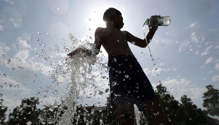 A boy plays with water in a fountain on a hot summer day in Brussels, Belgium, July 25, 2019. —Reuters