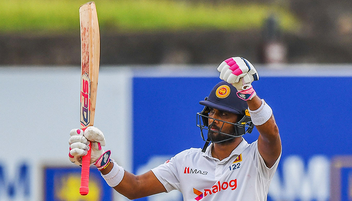 Sri Lankas Dinesh Chandimal celebrates after scoring a half-century (50 runs) during the third day of play of the first cricket Test match between Sri Lanka and Pakistan at the Galle International Cricket Stadium in Galle on July 18, 2022. — AFP