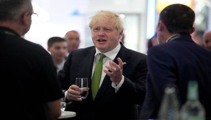 Britains Prime Minister Boris Johnson speaks to CEOs as he attends the Farnborough International Airshow, in Farnborough, Britain, July 18, 2022. —Frank Augstein/Pool via REUTERS