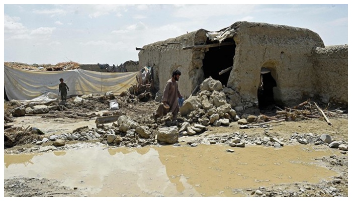 Residents clear debris of a damaged house due to a heavy monsoon rainfall on the outskirts of Quetta on July 5, 2022. — AFP