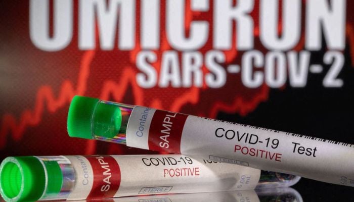Test tubes labelled COVID-19 Test Positive are seen in front of displayed words OMICRON SARS-COV-2 in this illustration taken December 11, 2021.— Reuters