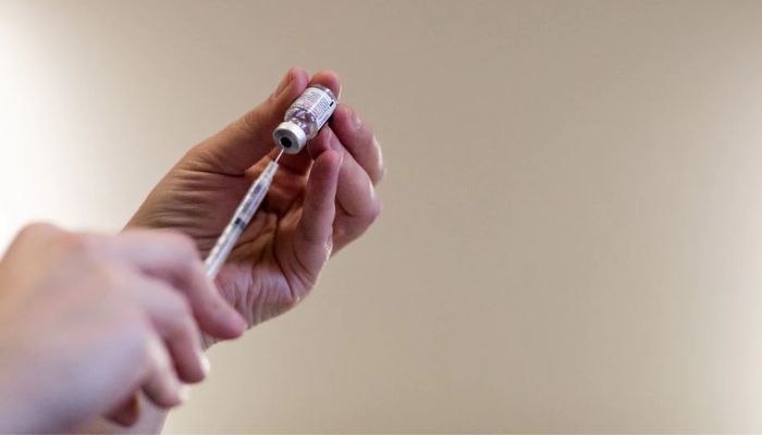 A nurse fills up syringes with the coronavirus disease (COVID-19) vaccines for residents who are over 50 years old and immunocompromised and are eligible to receive their second booster shots in Waterford, Michigan, US, April 8, 2022.