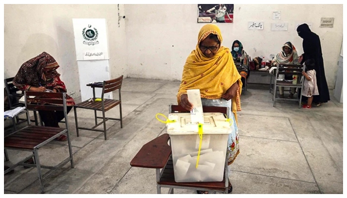 Voters cast their ballot at a polling station during the by-election in the Punjab province assembly seat in Lahore on July 17, 2022. — AFP