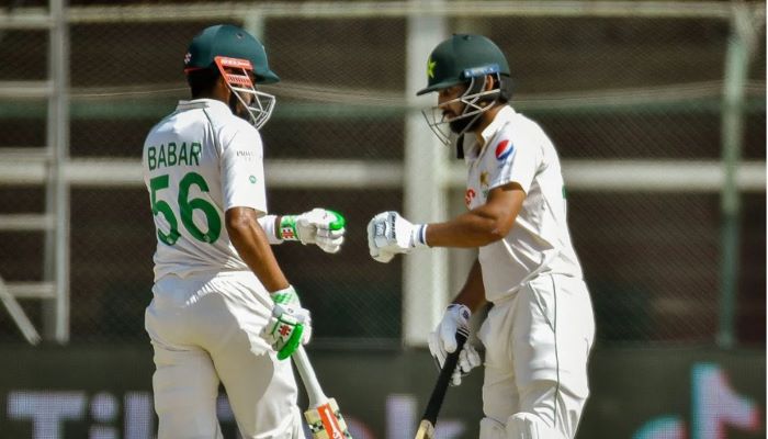 Babar Azam (left) and Abdullah Shafique bump fists after taking a run at the fourth day of the first Test in Galle, Sri Lanka. — Twitter