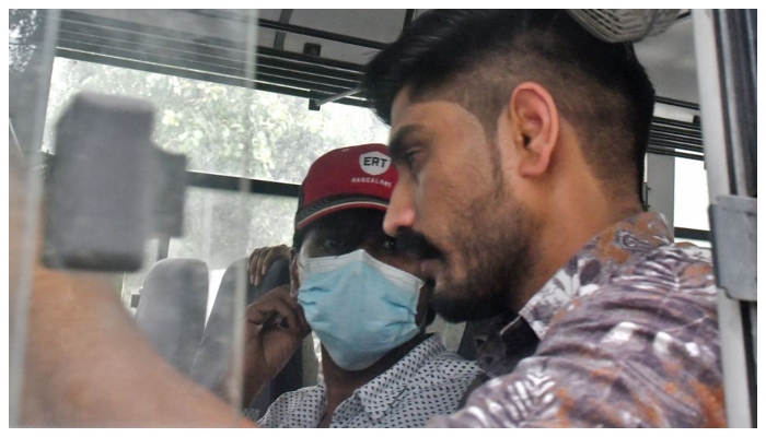 Mohammed Zubair, a journalist and a co-founder of fact-checking website Alt News sits in a police vehicle outside a court in New Delhi, India, June 28, 2022. — Reuters