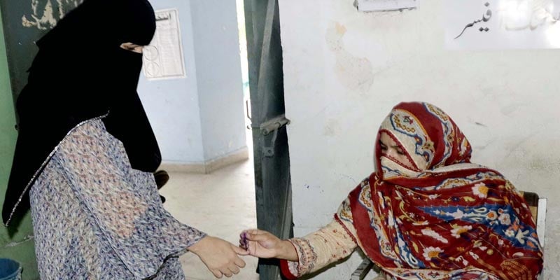 The ballot casting process is underway at a polling station during Local Bodies Election, held in Lahore on Sunday, July 17, 2022. PPI
