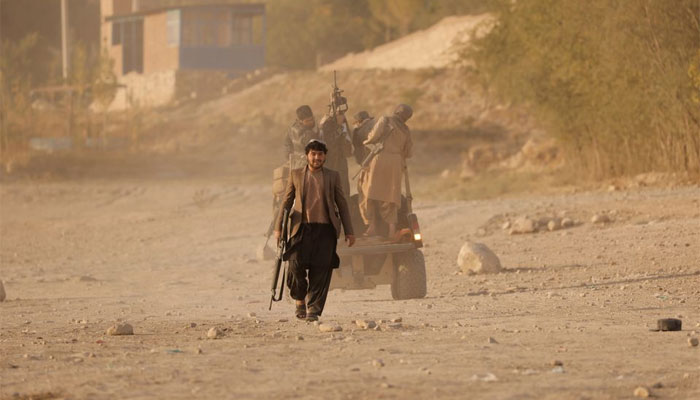 A Taliban fighter walks as he and others take a day off to visit the amusement park at Kabuls Qargha reservoir, at the outskirts of Kabul, Afghanistan October 8, 2021. Picture taken October 8, 2021. &mdash; Reuters