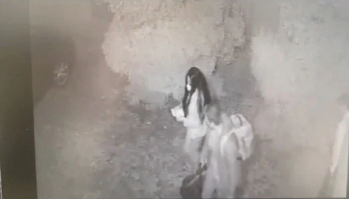 A man and a woman walk out from Restaurante Atrio, carrying three bags of stolen wine bottles worth up to &1.7 million, in Caceres, Spain October 27, 2021 in this frame grab taken from CCTV video released on July 20, 2022. — Reuters