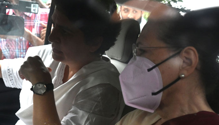 Indian Congress party leader Sonia Gandhi (R) leaves her residence accompanied with her daughter Priyanka Gandhi (L) and her son Rahul Gandhi (not pictured) for questioning in an alleged money laundering case at the Enforcement Directorate (ED) office, in New Delhi on July 21, 2022. — AFP