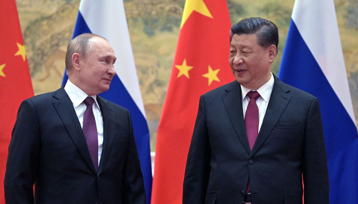 Russian President Vladimir Putin (left) and Chinese President Xi Jinping pose for a photograph during their meeting in Beijing on February 4. — AFP/File