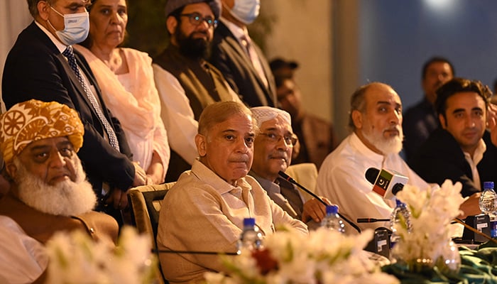 Coalition government leaders Prime Minister Shahbaz Sharif (C), PPP Co-chairman Asif Ali Zardari (R) and JUI-F chief Fazlur Rehman (L) speak during a press conference in Islamabad on March 28, 2022. — AFP