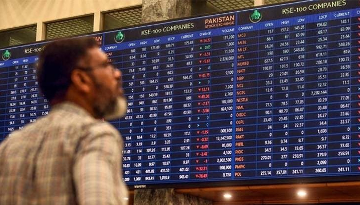 An investor looking at the benchmark KSE-100 index digital board at the Pakistan Stock Exchnage. — AFP/File