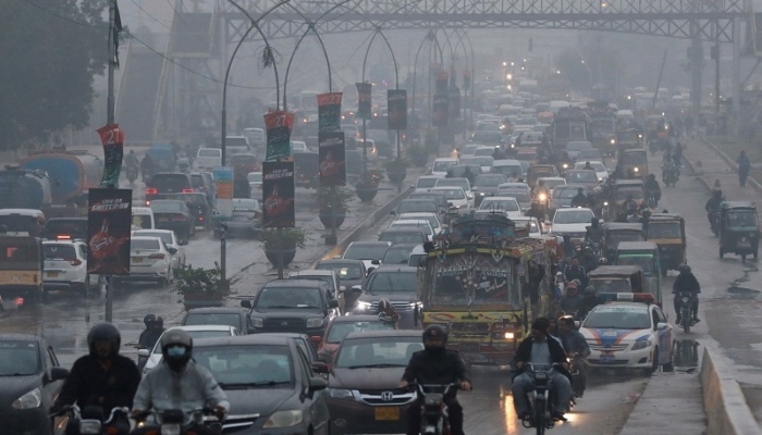 Vehicles move on a road during rainfall in Karachi, Pakistan on Monday, December 27, 2021. — Reuters/File