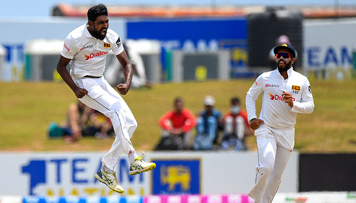 Sri Lankas Prabath Jayasuriya (L) celebrates after taking the wicket of Pakistans captain Babar Azam (not pictured) during the second day of the second cricket Test match between Sri Lanka and Pakistan at the Galle International Cricket Stadium in Galle on July 25, 2022. &mdash; AFP