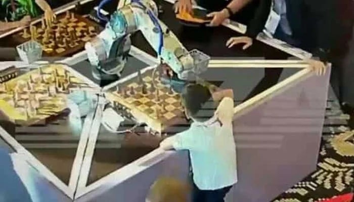 The picture shows a robot playing chess with a seven-year-old opponent. — Screengrab/Twitter