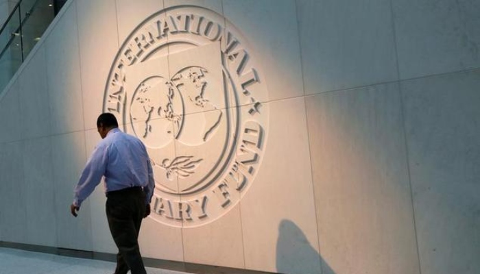 A man walks past the International Monetary Fund (IMF) logo at its headquarters in Washington, US, May 10, 2018. — Reuters/File