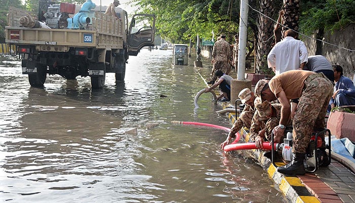 Pakistan Army personnel begin dewatering of rainwater accumulated in the Sindh Assembly area as monsoon rains let up in Karachi.— APP photo by M Saeed Qureshi