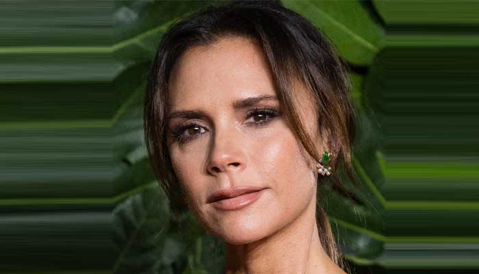 Victoria Beckham shows off her athletic physique in red swimsuit