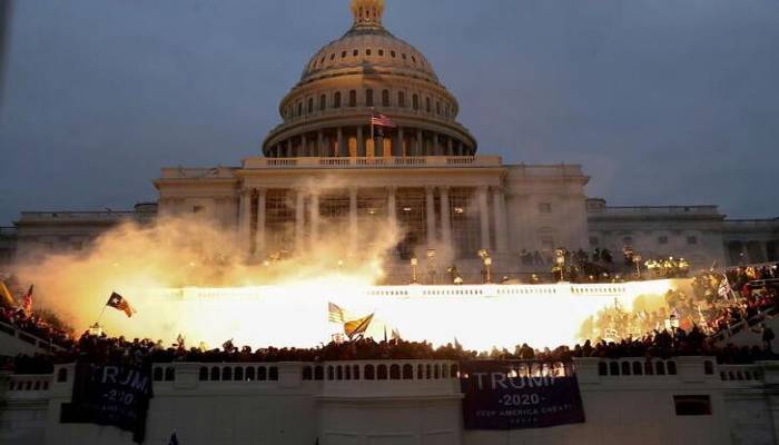 An explosion caused by a police munition is seen while supporters of US President Donald Trump gather in front of the US Capitol Building in Washington, US, January 6, 2021. —REUTERS/Leah Millis
