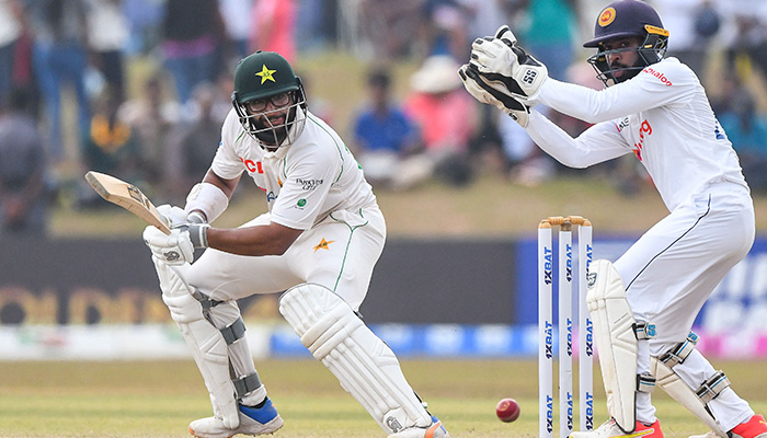 Pakistans Imam-ul-Haq (L) plays a shot as Sri Lankas wicketkeeper Niroshan Dickwella watches during the fourth day of the second cricket Test match between Sri Lanka and Pakistan at the Galle International Cricket Stadium in Galle on July 27, 2022. — AFP