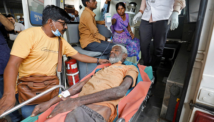 A man, who according to a doctor consumed spurious liquor, is brought to a hospital for treatment in Ahmedabad, India, July 27, 2022. — Reuters