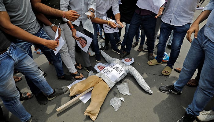 Members of the youth wing of Indias main opposition Congress party prepare to burn an effigy depicting Gujarat states Home Minister Harsh Ramesh Sanghvi during a protest against what they say is liquor sale, in Ahmedabad, India, July 27, 2022. — Reuters