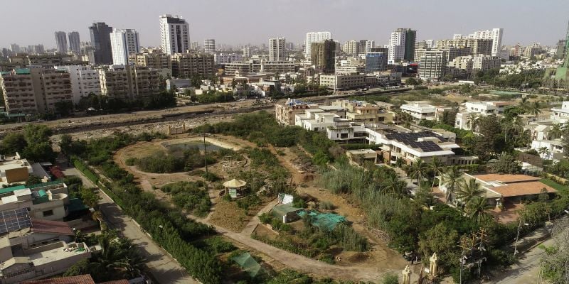 An aerial view shows the urban forest with the business district in the background in Karachi, Pakistan June 6, 2021.REUTERS