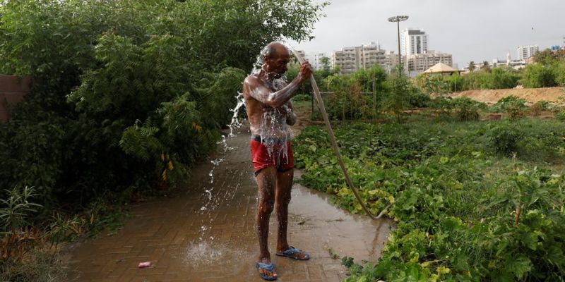 Mulazim Hussain, 61, a farmer at the urban forest plantation project, washes after work in Karachi, Pakistan July 10, 2021. I have raised these plants like my children over the last four years, he said. REUTERS