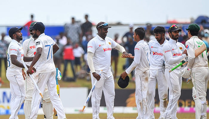 Sri Lankas Angelo Mathews (C) celebrates with teammates after Sri Lanka won by 246 runs at the end of the second cricket Test match between Sri Lanka and Pakistan at the Galle International Cricket Stadium in Galle on July 28, 2022. — AFP