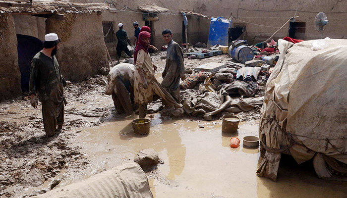 Residents clear the debris of a damaged house due to heavy monsoon rainfall at the Aghbarg area in Quetta, on July 20, 2022. — PPI