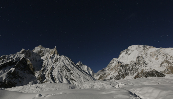 K2 (backdrop) and Broad Peak (right side), are illuminated by the moon at Concordia, the confluence of the Baltoro and Godwin-Austen glaciers, in the Karakoram mountain range in Pakistan September 7, 2014. — Reuters