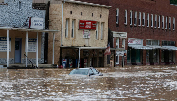 A car is submerged in flood waters along Right Beaver Creek, following a day of heavy rain in in Garrett, Kentucky, US July 28, 2022.— Pat McDonogh/USA TODAY NETWORK via REUTERS