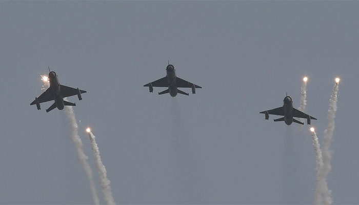 Three Soviet-era MiG-21 aircrafts flying in an air arms show. — AFP