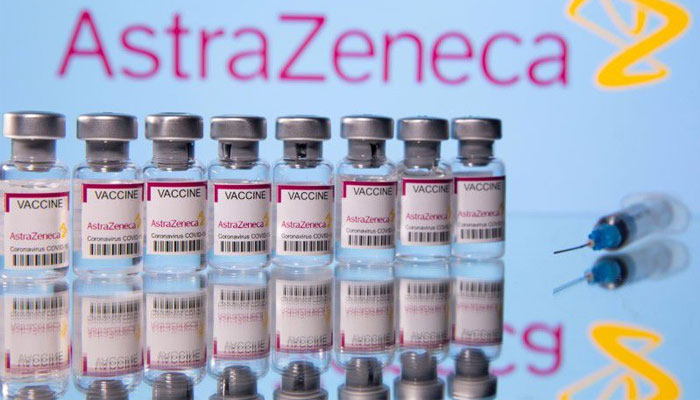 Vials labelled Astra Zeneca COVID-19 Coronavirus Vaccine and a syringe are seen in front of a displayed AstraZeneca logo, in this illustration photo taken March 14, 2021. REUTERS/Dado Ruvic/Illustration/File Photo