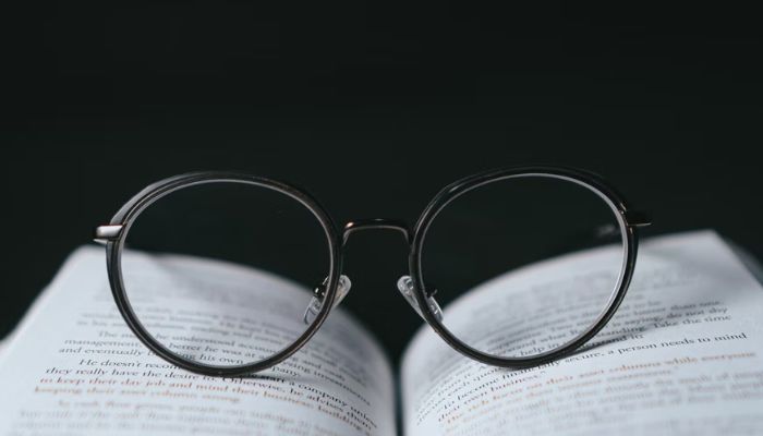 Eyeglasses resting on an open book.—Unsplash