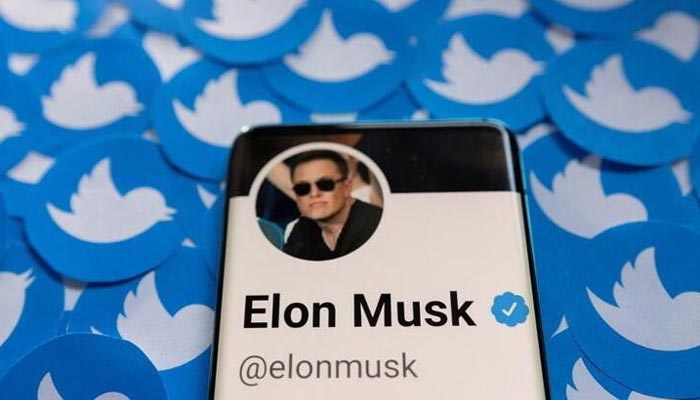 Elon Musks Twitter profile is seen on a smartphone placed on printed Twitter logos in this picture illustration. — Reuters/File