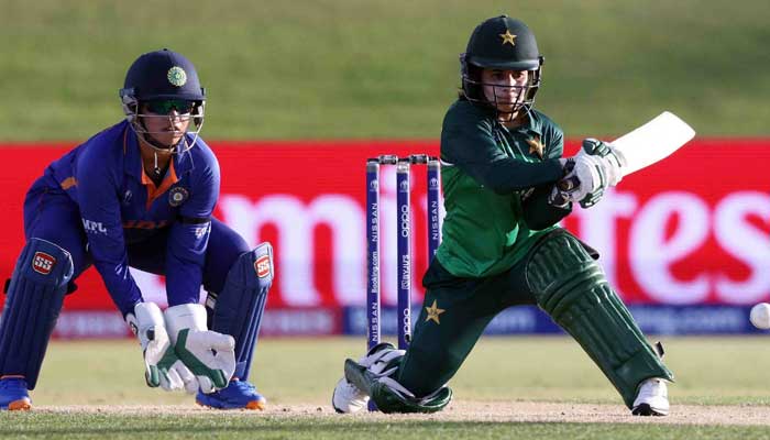 Pakistan’s Javeria Khan plays a shot while Indian wicketkeeper Richa Ghosh watching it. Photo: AFP/file