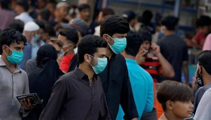 Men wearing protective face masks walk amid the rush of people outside a market during an outbreak of the coronavirus disease (COVID-19) continues, in Karachi, Pakistan June 8, 2020. — Reuters