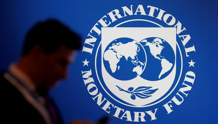 A participant stands near a logo of IMF at the International Monetary Fund - World Bank Annual Meeting 2018 in Nusa Dua, Bali, Indonesia, October 12, 2018. — Reuters