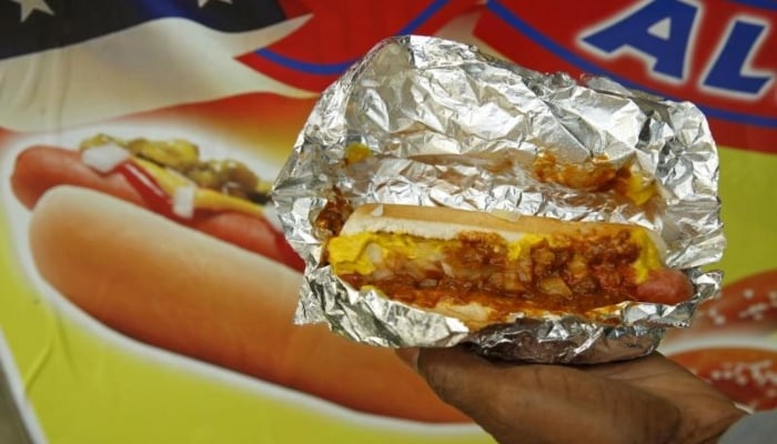 A man holds out a hot dog he bought from a street vendor in Washington October 26, 2015. — Reuters/File