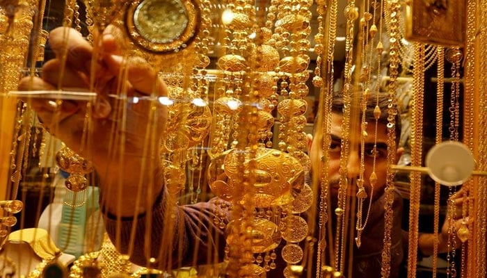 An Iraqi goldsmith arranges gold at his shop in Najaf, Iraq December 5, 2020. — Reuters/File