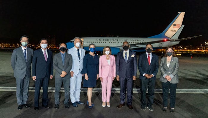 This handout picture taken and released by Taiwans Ministry of Foreign Affairs (MOFA) on August 2, 2022 shows Speaker of the US House of Representatives Nancy Pelosi posing with her delegation upon their arrival at the Sungshan Airport in Taipei. Photo: AFP