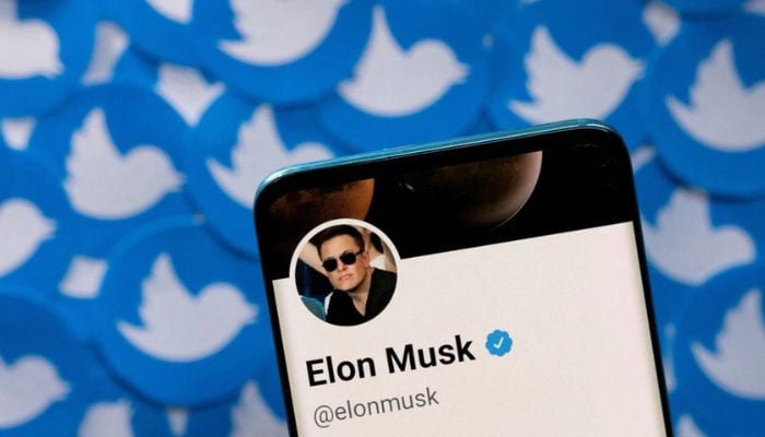 Elon Musks Twitter profile is seen on a smartphone placed on printed Twitter logos in this picture illustration taken April 28, 2022. — Reuters