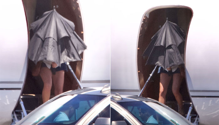 Taylor Swift seen hiding behind umbrella as she gets off private jet