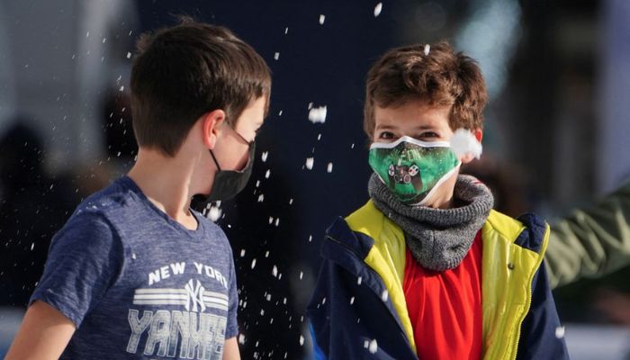 Children wearing protective masks toss snow at each other as they skate at Bryant Park during the coronavirus disease (COVID-19) pandemic in the Manhattan borough of New York City, New York, U.S., January 14, 2022.— Reuters